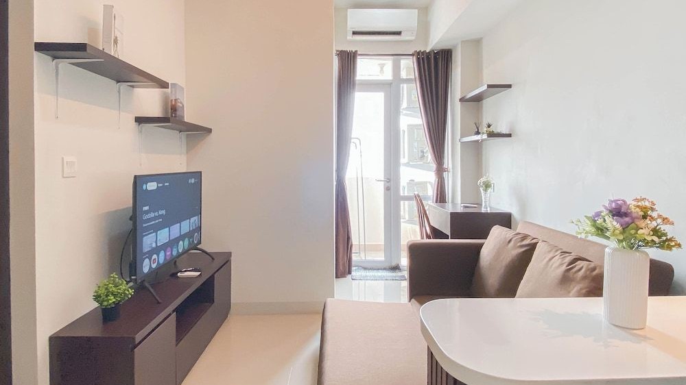 Ruang tamu apartemen modern dengan sofa minimalis dan dekorasi scandinavian